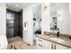 Modern bathroom features a glass-enclosed shower, dual vanities with gold hardware, and contemporary lighting at 4227 Mariposa St, Denver, CO 80211