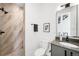 Modern bathroom featuring a glass shower with stone tile and contemporary fixtures at 4227 Mariposa St, Denver, CO 80211