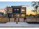 Modern two-story home featuring unique wood and brick accents, complemented by a sleek black facade at 4227 Mariposa St, Denver, CO 80211