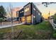 Modern home exterior showcasing sleek design, mixed materials, manicured lawn, and a stylish walkway at 4227 Mariposa St, Denver, CO 80211