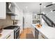 Modern kitchen showcasing sleek white cabinets, stainless steel appliances, and an open layout with hardwood floors at 4227 Mariposa St, Denver, CO 80211