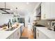 Bright, modern kitchen with stainless steel appliances, quartz countertops, and a view into the living area at 4227 Mariposa St, Denver, CO 80211