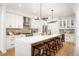 Bright, modern kitchen featuring a large island with seating, stainless steel appliances, and stylish lighting at 4227 Mariposa St, Denver, CO 80211