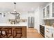 Bright kitchen featuring modern stainless steel appliances, white cabinetry and counter seating at 4227 Mariposa St, Denver, CO 80211