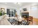 Bright living room with modern fireplace, hardwood floors, and access to outdoor dining area at 4227 Mariposa St, Denver, CO 80211