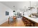 Open-concept kitchen and living area with modern lighting and hardwood floors at 4227 Mariposa St, Denver, CO 80211