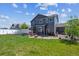 Expansive backyard showcasing a spacious lawn, shade structure, and a neatly maintained exterior of the home at 2431 Nicholson St, Berthoud, CO 80513