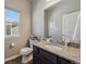 Stylish powder room featuring granite countertop vanity, decorative mirror, and modern fixtures, adding elegance at 2431 Nicholson St, Berthoud, CO 80513