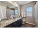 Bathroom with double sink vanity, granite countertops, and a large mirror with modern lighting at 2431 Nicholson St, Berthoud, CO 80513