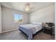 Bedroom with a bed and neutral walls featuring one window and a bedside table at 2431 Nicholson St, Berthoud, CO 80513
