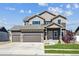 Beautiful two-story home boasts a three-car garage, manicured lawn and stone accents, offering modern comfort at 2431 Nicholson St, Berthoud, CO 80513