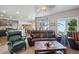 Spacious living room with hardwood floors, seamlessly connects to the kitchen, creating an open and welcoming space at 2431 Nicholson St, Berthoud, CO 80513