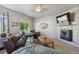 Cozy living room with a stone fireplace, TV, and comfortable seating creating an inviting atmosphere at 2431 Nicholson St, Berthoud, CO 80513