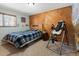Bedroom with wood accent wall and inversion table at 11724 Little Turtle Ln, Conifer, CO 80433