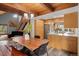 Open concept dining area and kitchen with wood accents, modern appliances, and a spacious dining table at 11724 Little Turtle Ln, Conifer, CO 80433