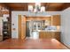 View of updated kitchen with wood cabinets, stainless appliances, and wooden beam accents at 11724 Little Turtle Ln, Conifer, CO 80433