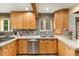Kitchen with custom cabinets, modern countertops, stainless steel appliances, and stylish backsplash at 11724 Little Turtle Ln, Conifer, CO 80433
