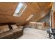 Attic living space with wooden ceiling and skylights at 11724 Little Turtle Ln, Conifer, CO 80433