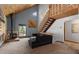 Cozy living room with a wood-burning stove, vaulted ceilings, and open staircase at 11724 Little Turtle Ln, Conifer, CO 80433