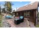 A stunning stone patio features comfortable seating areas for outdoor relaxation and entertaining at 11724 Little Turtle Ln, Conifer, CO 80433