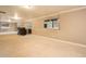 Large basement with carpet, bar, and view to backyard at 10 Long Bow Cir, Monument, CO 80132