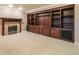 Spacious basement area with built-in shelves, cabinets, and a cozy fireplace at 10 Long Bow Cir, Monument, CO 80132