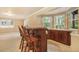 Basement features a bar, granite counters, and a built-in sink beneath large windows at 10 Long Bow Cir, Monument, CO 80132