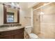 Bathroom featuring a glass enclosed shower, granite countertop and cherrywood vanity with updated fixtures at 10 Long Bow Cir, Monument, CO 80132