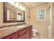 Bathroom features a marble countertop vanity with a large, framed mirror and tile backsplash at 10 Long Bow Cir, Monument, CO 80132