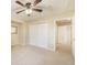 Large bedroom with a ceiling fan, neutral carpet, and double door closet at 10 Long Bow Cir, Monument, CO 80132