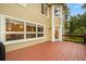 Large wooden deck with white trim, offering views of mature trees and landscaping, perfect for entertaining at 10 Long Bow Cir, Monument, CO 80132