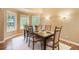Bright dining room featuring ample natural light, a large table with seating for six, and hardwood flooring at 10 Long Bow Cir, Monument, CO 80132