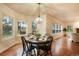 Bright dining area with hardwood floors features large windows overlooking the backyard at 10 Long Bow Cir, Monument, CO 80132
