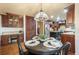 Open-concept dining area is adjacent to the kitchen with dark wood cabinetry at 10 Long Bow Cir, Monument, CO 80132