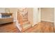 Inviting entryway with hardwood floors, a staircase with wood banister, and neutral walls creating a warm atmosphere at 10 Long Bow Cir, Monument, CO 80132