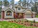 Exterior of this two-story home with a brick facade, manicured flower beds and a three-car garage at 10 Long Bow Cir, Monument, CO 80132