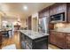 Well-lit kitchen features stainless steel appliances, granite countertops, and dark wood cabinetry at 10 Long Bow Cir, Monument, CO 80132