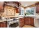 Stainless steel stove is surrounded by custom backsplash and cabinetry near the bright windows at 10 Long Bow Cir, Monument, CO 80132