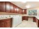 Spacious laundry room with plenty of counter space, cabinets, sink and front loading washer and dryer at 10 Long Bow Cir, Monument, CO 80132