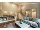 Open-concept living and dining area with hardwood floors, neutral walls, and ample natural light creating an inviting space at 10 Long Bow Cir, Monument, CO 80132