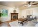 Cozy living room featuring a decorative fireplace, hardwood flooring and large windows at 10 Long Bow Cir, Monument, CO 80132