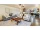 Open concept living room features wood floors and leads to a kitchen and dining area at 10 Long Bow Cir, Monument, CO 80132