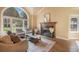 Relaxing living room featuring a fireplace with wood trim, a large window, and comfortable seating for guests at 10 Long Bow Cir, Monument, CO 80132