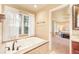 Spa-like main bathroom features a jacuzzi tub, tile accents, and elegant fixtures at 10 Long Bow Cir, Monument, CO 80132