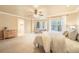 Bright main bedroom boasts large windows, neutral tones, and an ensuite bathroom at 10 Long Bow Cir, Monument, CO 80132