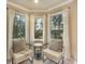 Cozy sitting area by bay windows with comfortable chairs and serene views at 10 Long Bow Cir, Monument, CO 80132