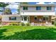 Spacious backyard with lush lawn, brick accents, and views of the home's exterior at 7970 S Cook Way, Centennial, CO 80122
