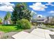 Scenic backyard featuring stone landscaping, lawn, shed, and outdoor seating area at 7970 S Cook Way, Centennial, CO 80122