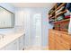 A bathroom featuring double sinks, wood cabinets, and doorway to shower at 7970 S Cook Way, Centennial, CO 80122