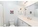 Bathroom featuring toilet, single sink vanity, and mirror at 7970 S Cook Way, Centennial, CO 80122